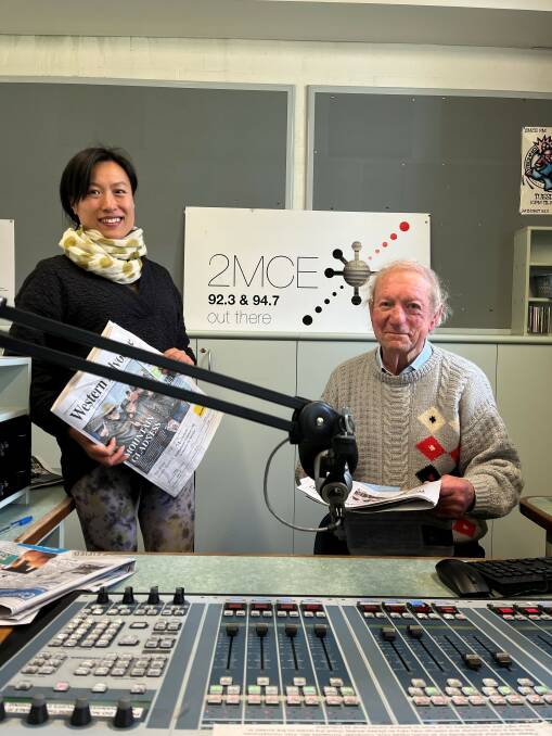 Volunteers Miao Li and Chris Bacon sitting behind the 2MCE panel. Picture supplied