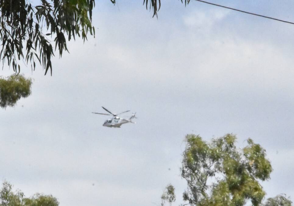 AIRLIFTED: A helicopter leaving the scene of the crash on Friday.