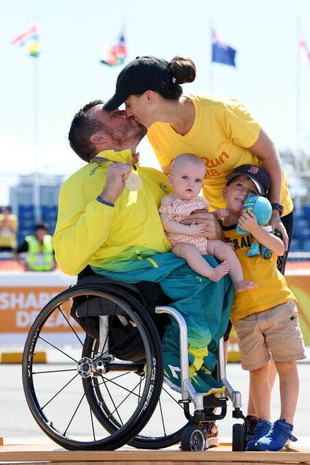 BACKED BY FAMILY: Kurt Fearnley with his wife Sheridan and their children Emilia and Harry, following his gold medal win. Photo: AAP, DEAN LEWINS