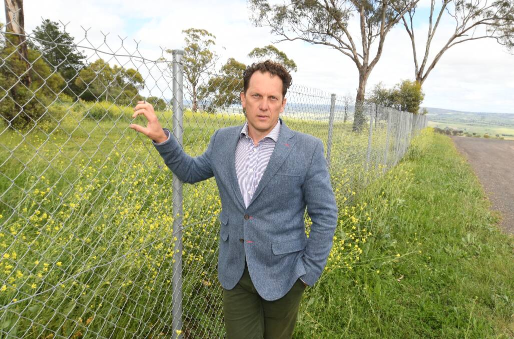 Councillor Jess Jennings alongside the fence separating the previous site for the Bathurst go-kart track from the rest of McPhillamy Park. 
