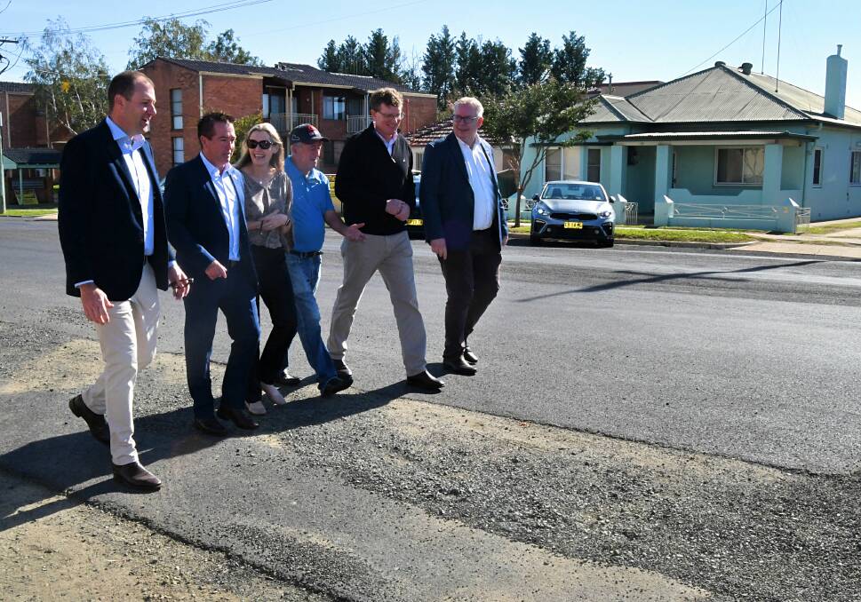 IN NEED OF IMPROVEMENT: Politicians and Transport for NSW staff looking at the surface of Piper Street on Wednesday.