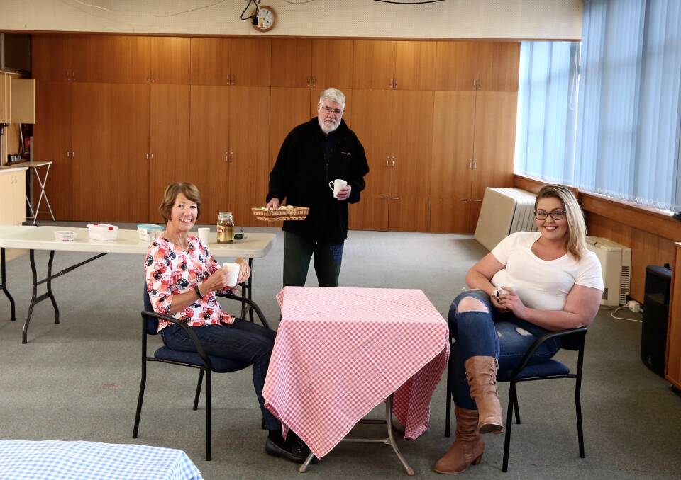 HELPING HAND: Uniting Safe Shelter (USS) volunteers Judy Tyson, Tim Collette and Kiya Colebrook in the church hall's activities room, where the cafe will be. Photo: PHIL BLATCH
