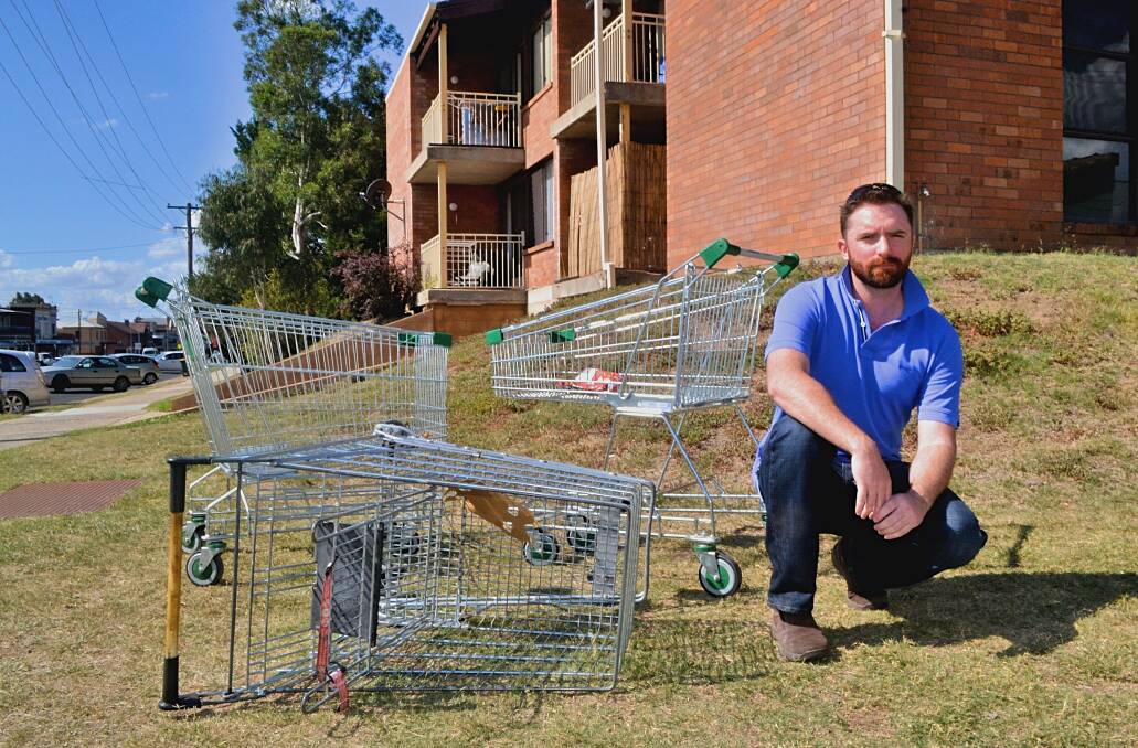 REOCCURRING PROBLEM: Councillor Alex Christian pictured with some abandoned trolleys in the Bathurst central business district in 2018. 