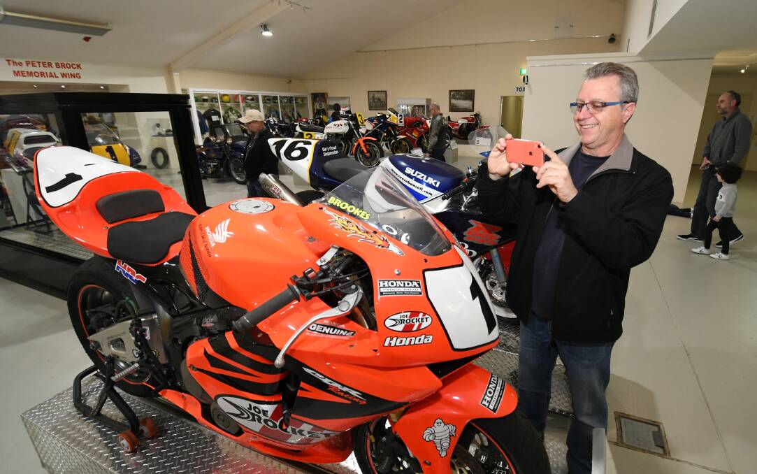 QUICK SNAP: Ross Brown, from Sydney, at the National Motor Racing Museum, taking a photo of a Honda CBR 600RR, which was raced by Josh Brookes in 2005. Photo: CHRIS SEABROOK 090119cmtp1
