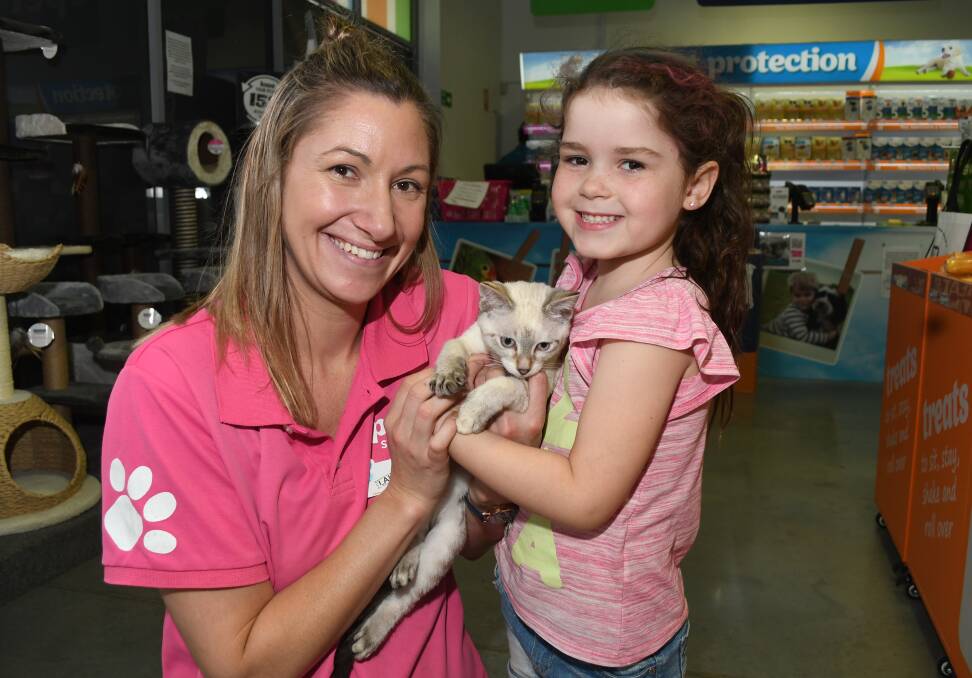 HAPPY: PETstock store manager Lauren Brooker with her seven-year-old daughter Alice and Vanilla, a kitten up for adoption. Photo:CHRIS SEABROOK 010819cpets1