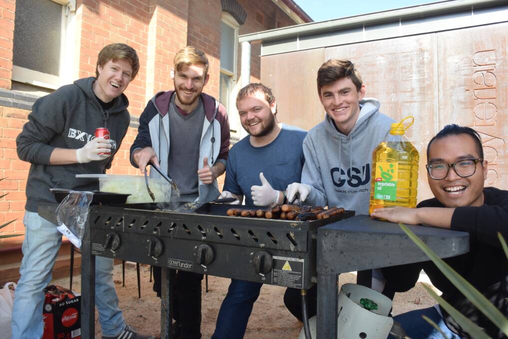 MANNING THE BURNERS: Volunteers ready to cook up as many as 400 sausages on election day. Photo: RACHEL CHAMBERLAIN