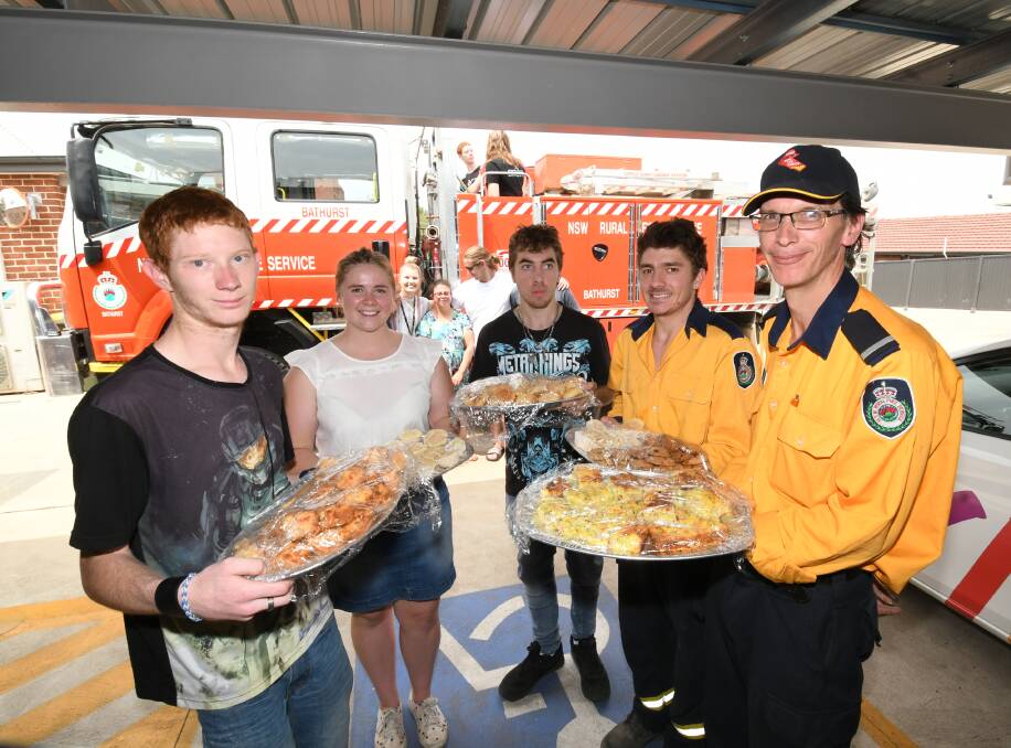 GIVING: Vivability clients Cameron Potts and Zach Spinazza, with support worker Georgina Shiels, NSW RFS volunteer Anthony Coan and deputy captain George Nicholls. Photos: CHRIS SEABROOK 011520cfood2