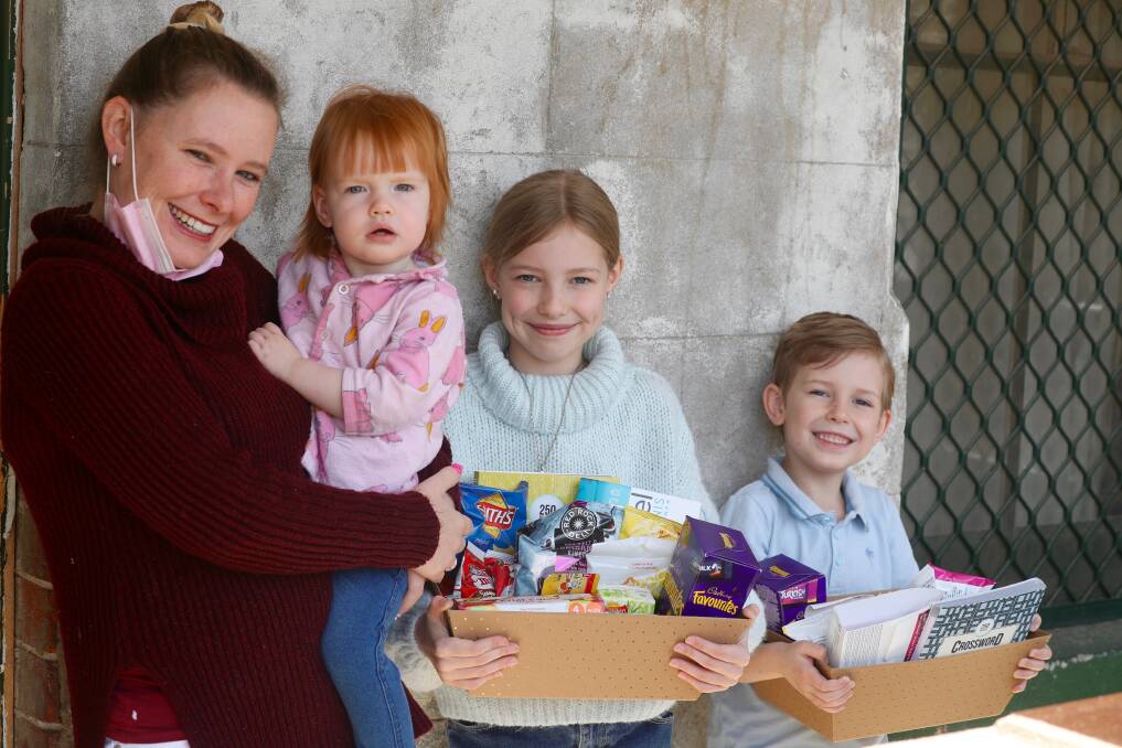 COMMUNITY PROJECT: Kathleen Fearn with her children Victoria, Cassandra and Austin, and the hampers she is creating. Photo: PHIL BLATCH