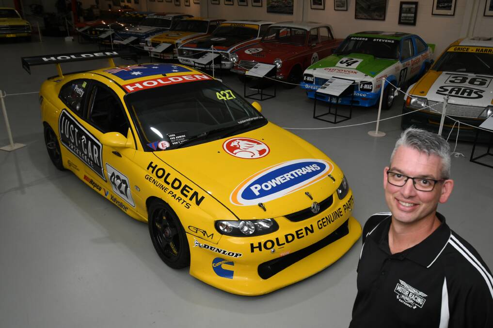 PIECE OF HISTORY: Museum manager Brad Owen with the Holden Monaro 427 that won the first Bathurst 24 Hour. Photo: CHRIS SEABROOK