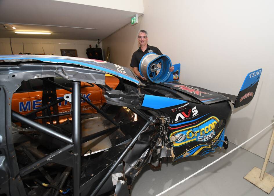 DAMAGED GOODS: The National Motor Racing Museum's Brad Owen with Chaz Mostert's Ford Falcon GX, which was involved in a horrific crash at Mount Panorama in 2015. 