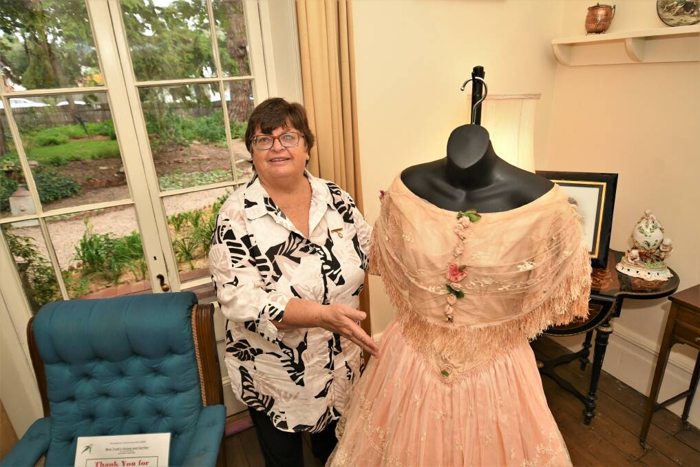 A PIECE OF HISTORY: Cavalcade of History and Fashion presentations coordinator Rachel King with Emily Kite's ballgown. Photo: CHRIS SEABROOK