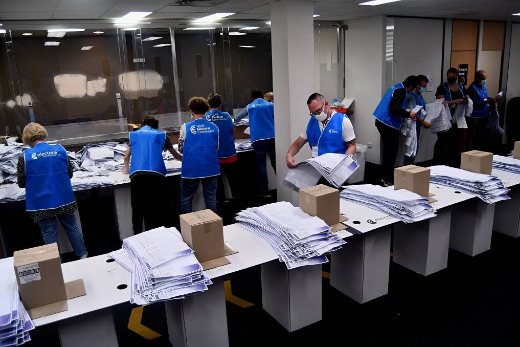 COUNTING: Election staff began counting pre-poll votes in the returning officer's office after polls closed on Saturday. Photo: RACHEL CHAMBERLAIN