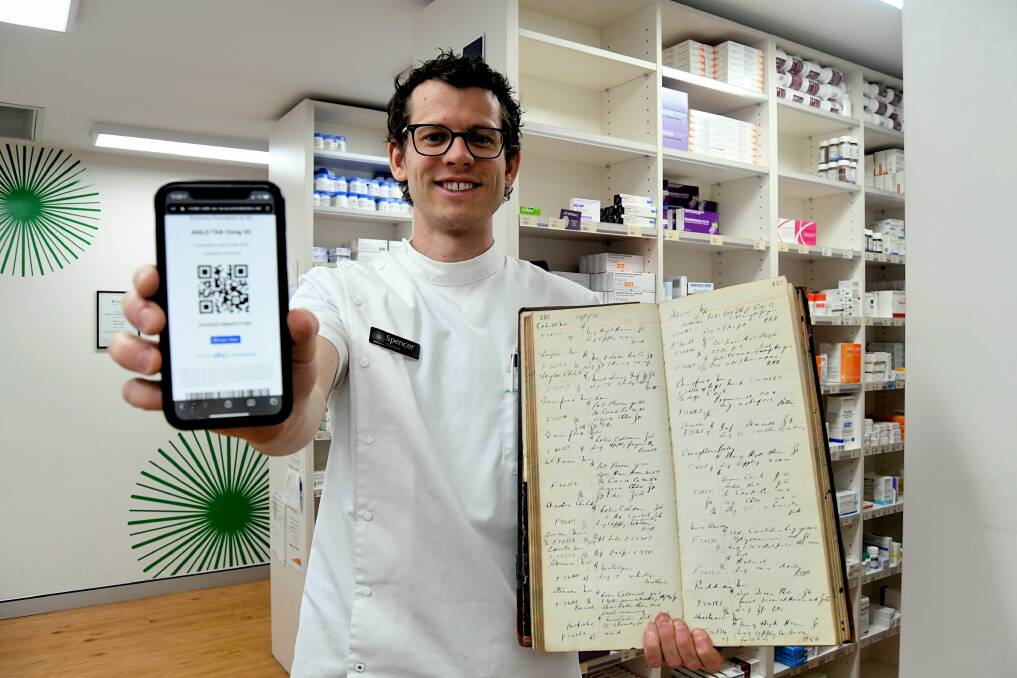 NEW TECHNOLOGY: Pharmacist in charge at Moodie's Pharmacy, Spencer McTavish, shows the new way and an old way of managing prescriptions. Photo: RACHEL CHAMBERLAIN