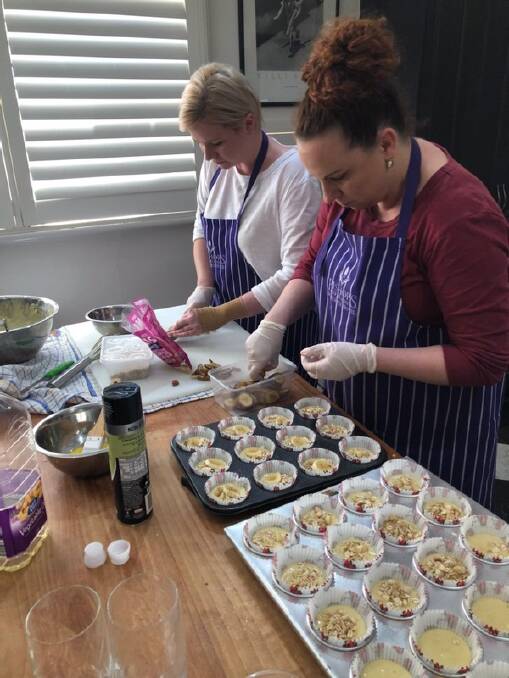 BUSY BEES: Chloe Somerville and Laura preparing food on Thursday morning for Walkinshaw Andretti United. Photo: SUPPLIED
