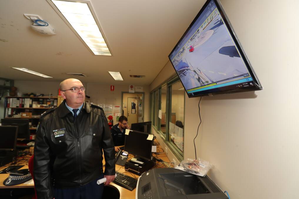 NEW TOOL: Superintendent Paul McDonald at Bathurst Police Station, looking at a screen displaying live images from one of the new closed-circuit television (CCTV) cameras. Photo: PHIL BLATCH 070919pbcctv1