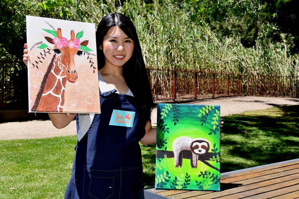 DO IT YOURSELF: Artist Joanne Wu with examples of the paintings people get to make at a Tipsy Creations workshop. Photo: RACHEL CHAMBERLAIN