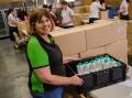 HopeCare's Cheryl Blackwell with stock and hampers that have already been packed. Picture by James Arrow