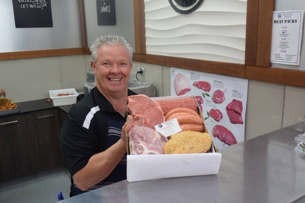 NEW OFFERING: Mountain Meats owner Paul Smith showing off some of the things you can get delivered to your home in the new Buy Local boxes. Photo: RACHEL CHAMBERLAIN