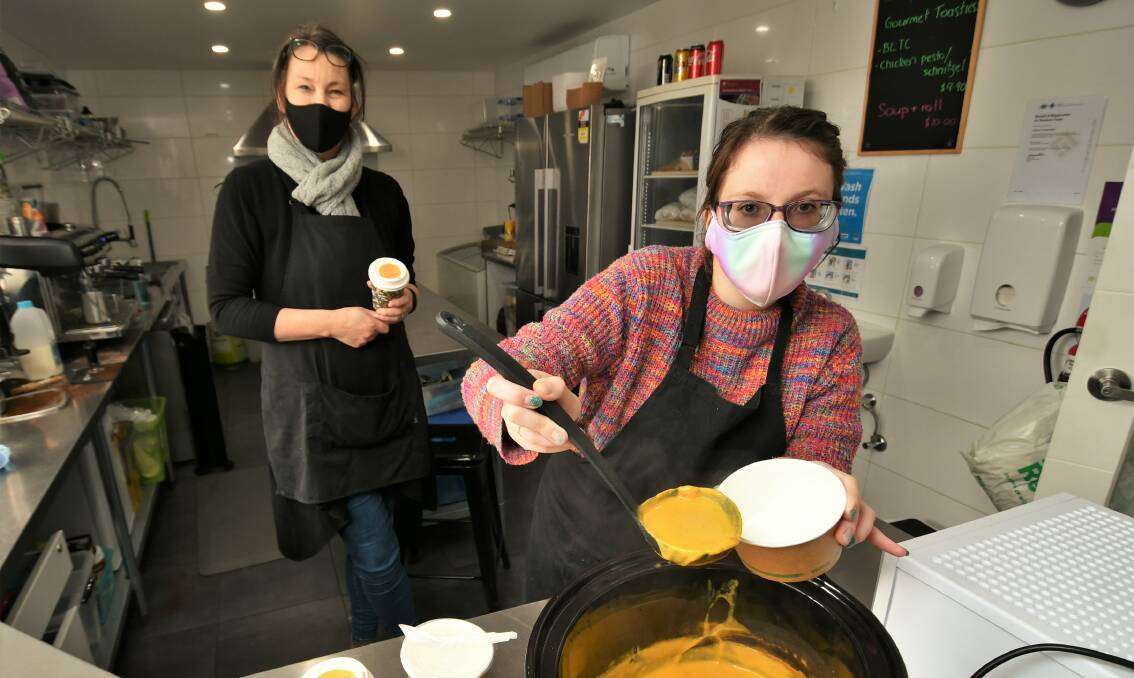 OPEN FOR BUSINESS: Café on Corporation project manager Carol Smith with staff member Lara Matheson, dishing up roasted pumpkin soup. Photo: CHRIS SEABROOK 090621cafecorp1