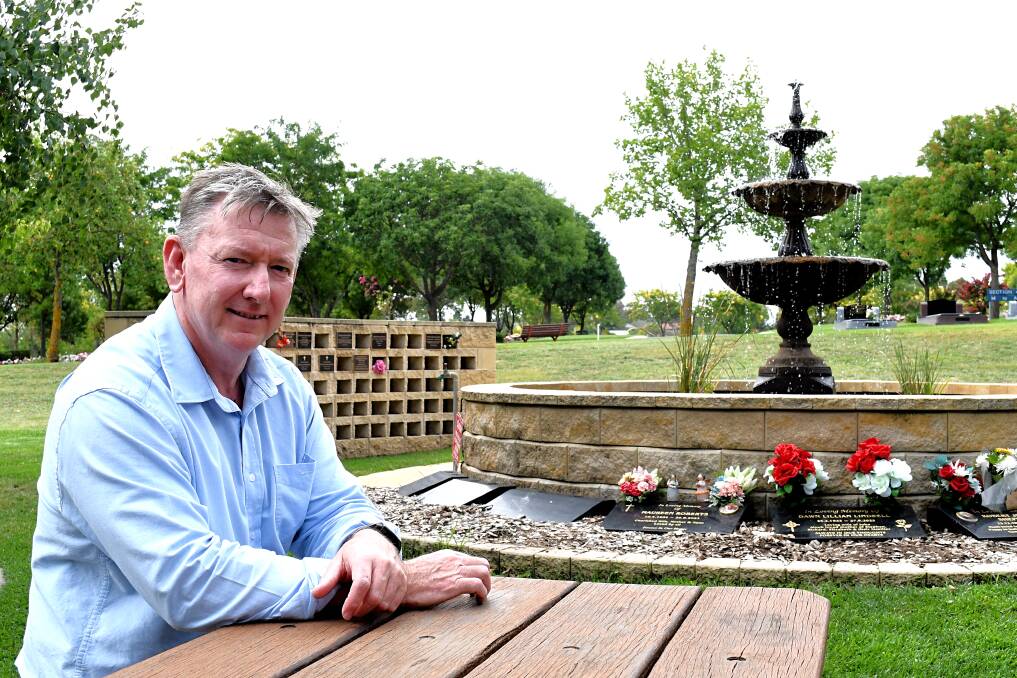Norwood Park General manager Michael Bridges sitting in front of the fountain in Bathurst cemetery, near a wall where ashes are interred. Picture by Rachel Chamberlain
