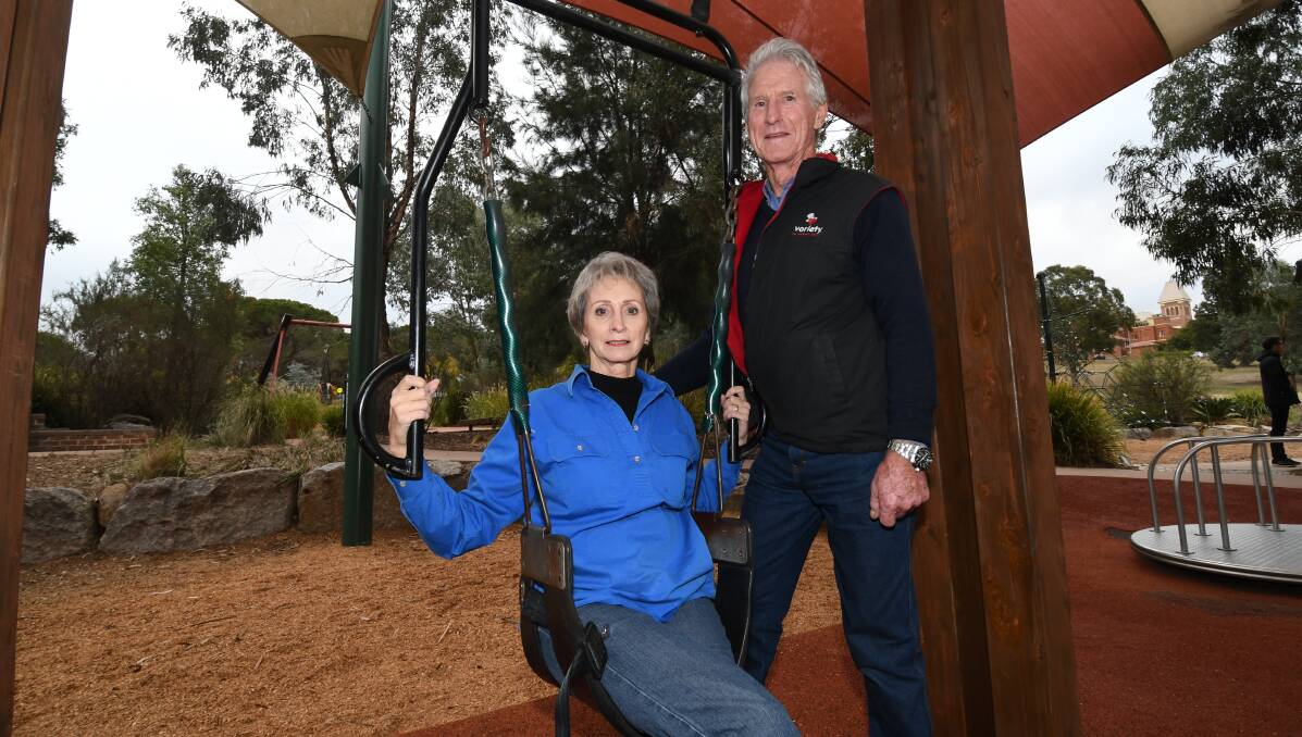 IN THE SWING: Linda and Graeme Gillbanks want to see a Liberty Swing installed in the adventure playground. Photo: CHRIS SEABROOK