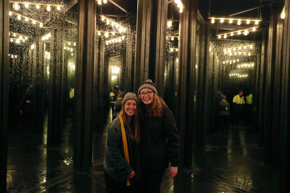 HAPPY TO EXPLORE: Olivia Maksynczuk and Kathleen Murphy in the mirror maze, a new attraction for the Bathurst Winter Festival. Photo: PHIL BLATCH 070718pbfest13