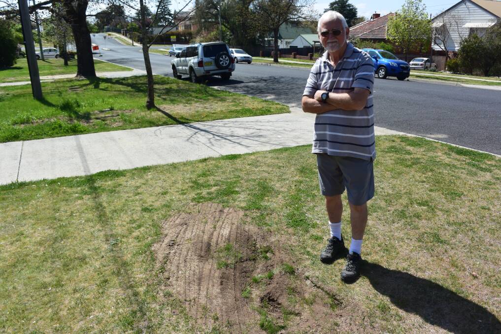 WATER ISSUE: Hope Street resident David McKinnon next to one of the spots council workers dug up when trying to find a leak.