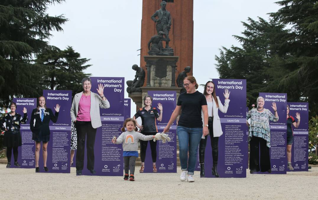 INSPIRING: Joanna Prior and her three-year-old daughter Evelyn admiring the International Women's Day display in Kings Parade. Photo: PHIL BLATCH 