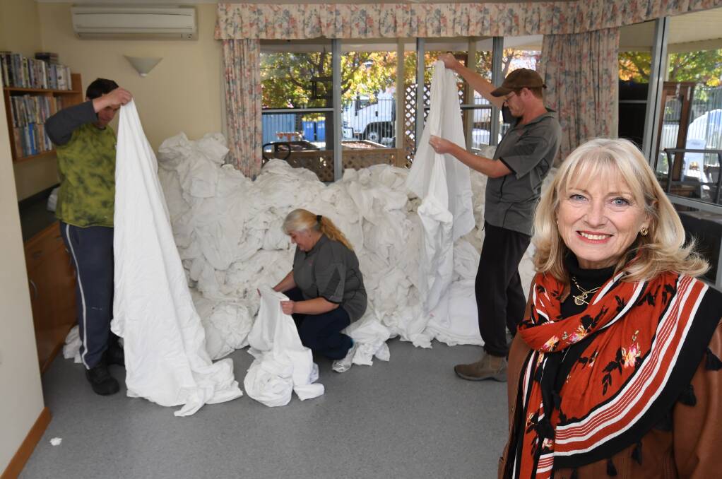 WORKING HARD: Glenray Industries CEO Susan Williams with staff, seen sorting linen at the former St Catherine's Nursing Home site. Photo: CHRIS SEABROOK 051518cglenray