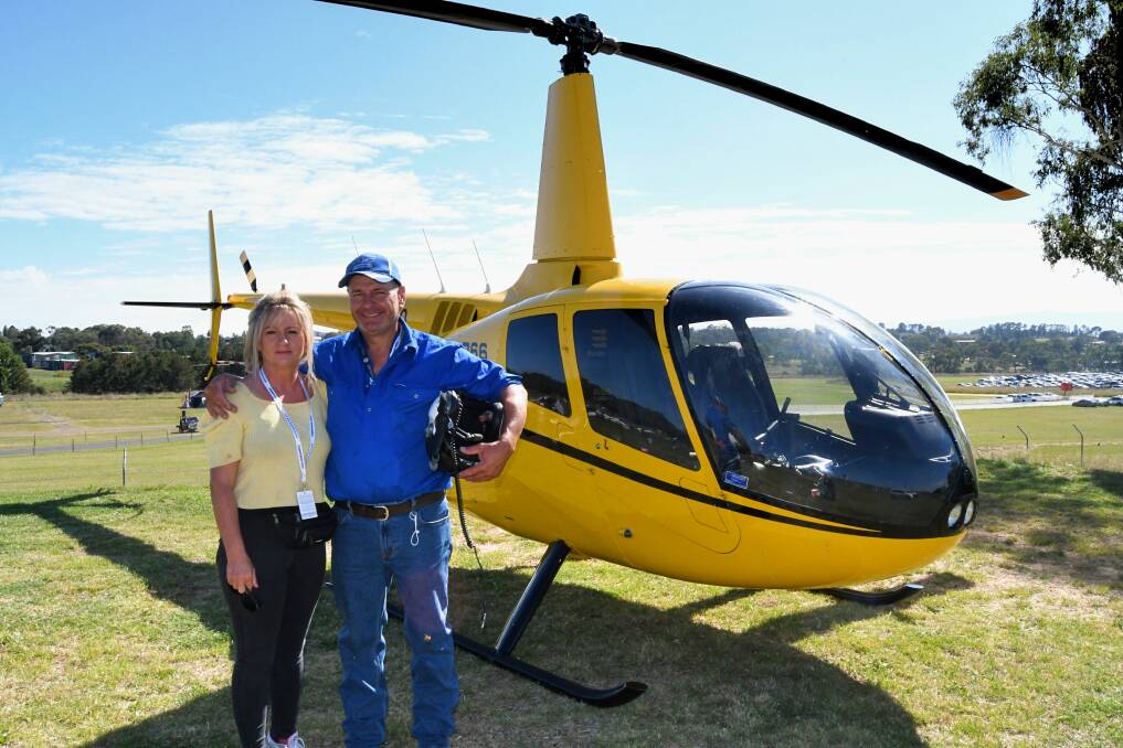 TAKE FLIGHT: Kylie Godden and her partner, pilot Mark Lilley, from Capertee Valley Helicopters. They are offering joy rides at Mount Panorama for the Bathurst 500. Photo: RACHEL CHAMBERLAIN 022721rcfly