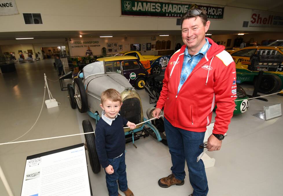 VISITORS: Johnson, 6, with his dad, David Husband, were at the National Motor Racing Museum on Father's Day. They came from Mudgee. Photo: CHRIS SEABROOK 090218cdadsday3