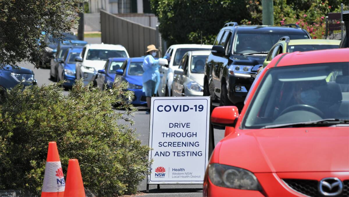 LONG WAIT FOR TESTS: Cars queuing at the drive-through COVID testing site in the former Clancy Motors car yard on Tuesday. Photo: CHRIS SEABROOK 010422covidchek1
