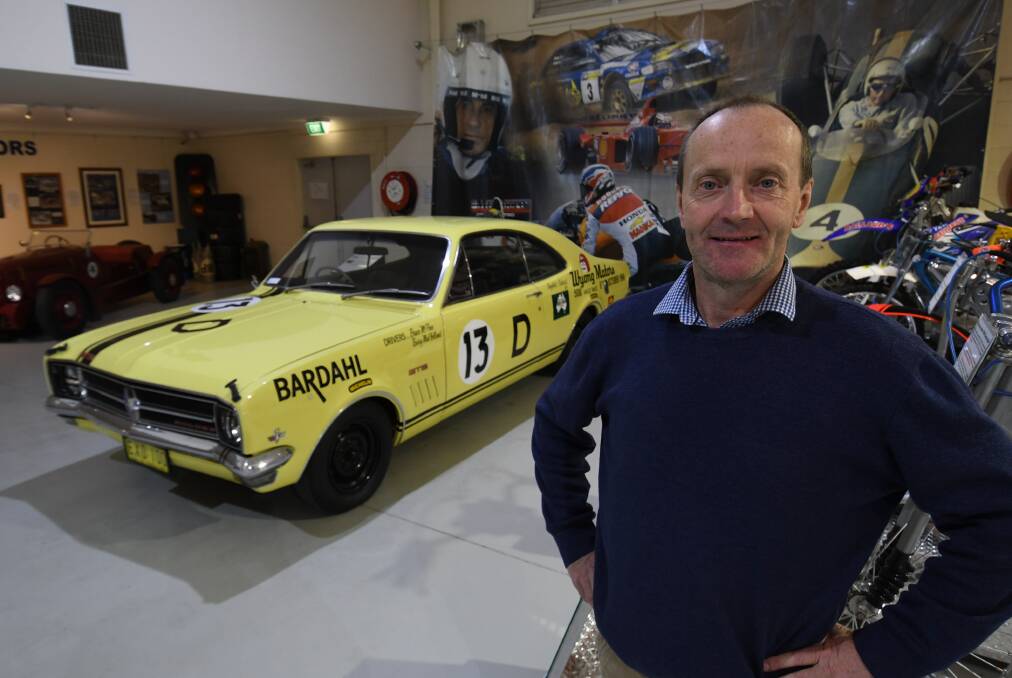 PIECE OF HISTORY: National Motor Racing Museum collections manager Tim Pike with a replica of the Holden Monaro (HK) GTS 327 that recorded Holden's first victory 50 years ago in 1968. Photo: CHRIS SEABROOK 081518cbx1000