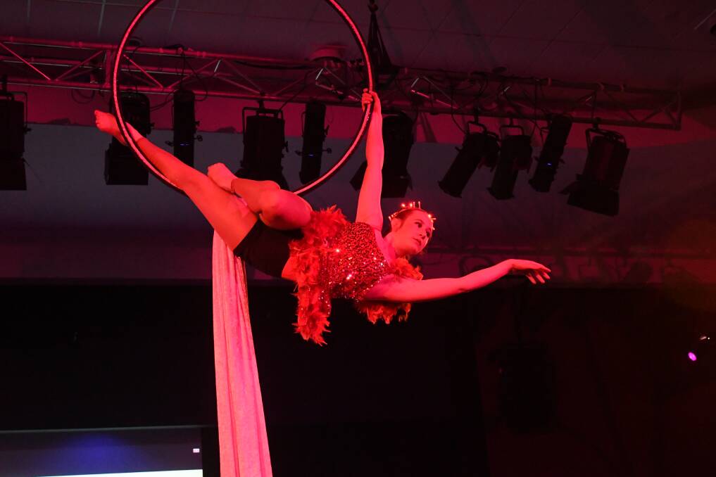 GRACEFUL: Cirkus Surreal's Tia Muggleton preforming on the lyra at the Rise Black Tie Ball on Saturday. Photo: CHRIS SEABROOK 080418cgball15