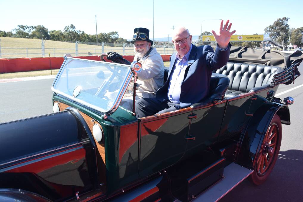 PIECE OF HISTORY: Horseless Carriage Club of America rally director Russell Holden at Mount Panorama, driving his car with mayor Graeme Hanger riding shotgun. Photo: RACHEL CHAMBERLAIN