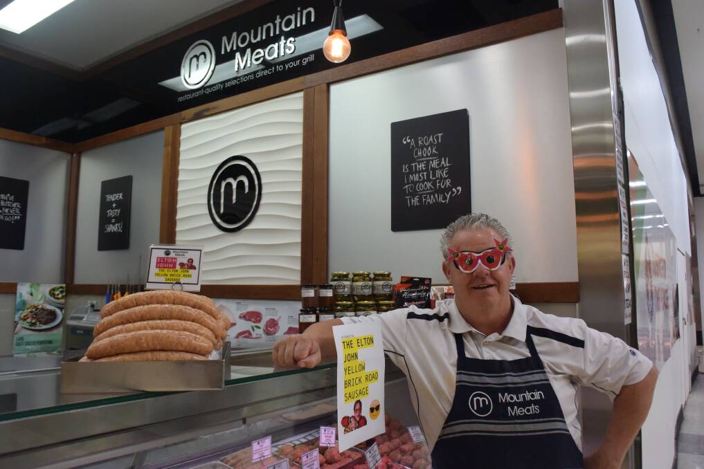 A BIT OF FUN: Mountain Meats owner Paul Smith with the Yellow Brick Road sausages created to celebrate the Sir Elton John concert. Photo: RACHEL CHAMBERLAIN 012220rcmeat1
