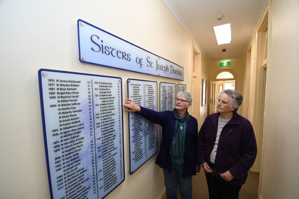 TOURS: Sister Mary Murphy and Sister Maureen Sanderson, pictured in 2019, looking at a panel detailing the sisters who were at the Perthville since 1876. Photo: CHRIS SEABROOK 091019csistrs1