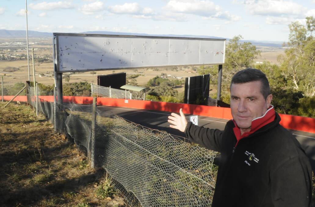 BLANK CANVAS: Councillor Warren Aubin isn't happy with billboards around Mount Panorama not being utilised between major motor sport events and has a suggestion of how they can be used. Photo: CHRIS SEABROOK 071817csigns