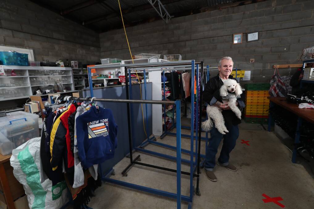 STOCKS ARE LOW: Bathurst Salvation Army Family Store manager Steve Barrott and his dog, Bobby, standing by the empty coat racks. Photo: PHIL BLATCH
