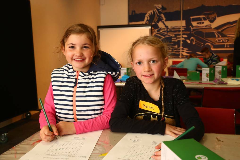 ALWAYS FUN: Liana Schmidt and Isabel Clements enjoyed one of Bathurst Library's workshops during the winter school holidays last year. Photo: PHIL BLATCH 070417pbsnow7