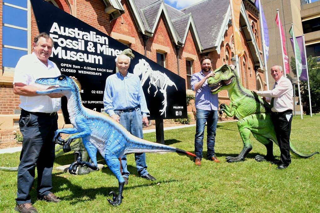 DONATION: Peter Rogers and Dale Ridderford presenting the fibreglass dinosaurs to councillor Alex Christian and mayor Bobby Bourke. Photo: RACHEL CHAMBERLAIN 121020rcdino