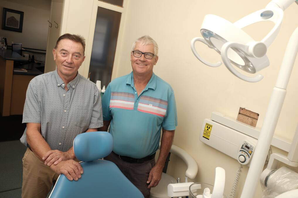 Dr Nigel Swan and Dr David Travis standing behind a dental chair. Picture by James Arrow