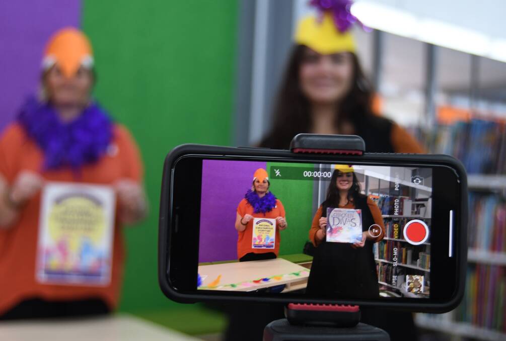 FUN EVENT: Rhiannon Mijovic and Victoria Murray from Bathurst Library show how storytime will be live-streamed. Photo: RACHEL CHAMBERLAIN 