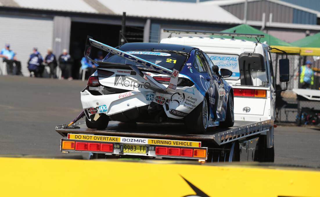 BROKEN: Macauley Jones's Commodore returning to the pit lane after a crash at The Cutting halfway through practice one. Photo: PHIL BLATCH