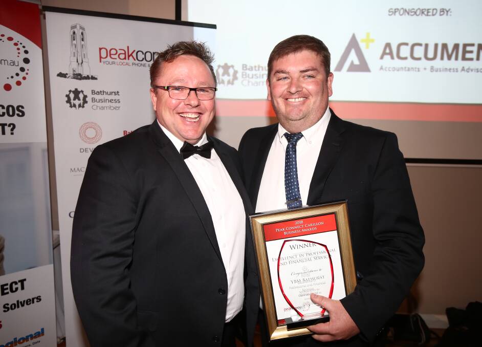 Reward for effort: Lawrie Breen from Inland Digital presents Brad Evans with YBM's award for Excellence in Professional and Financial Services. Photo: Phil Blatch.
