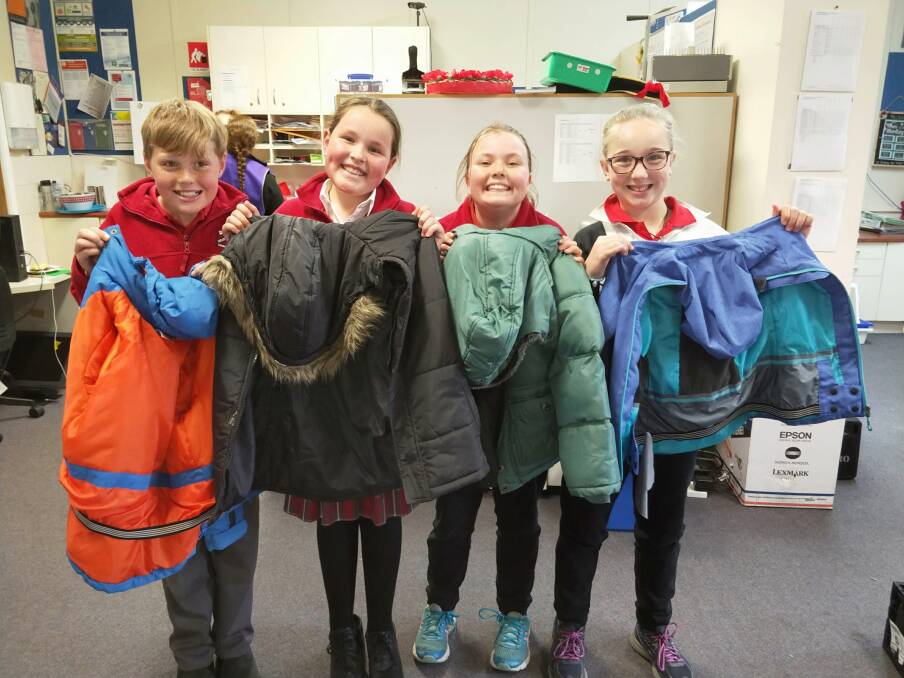 WARM SMILES: Happy students from Meadow Flat did a great job helping those who are less fortunate and suffering during the cold winter. Photo: Supplied.
