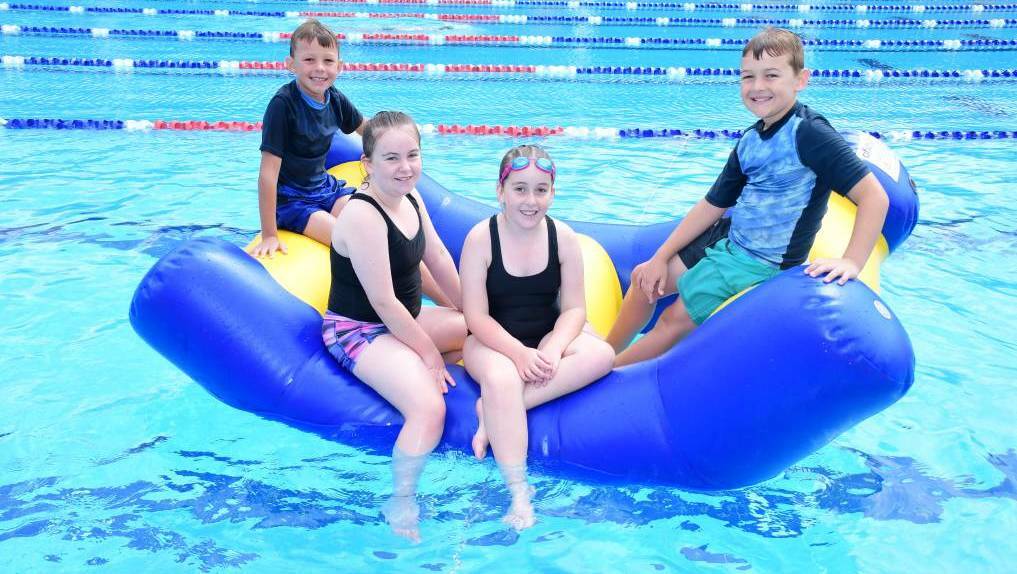 Ayden Powyer, Briannah and Madalyn Hundy with Cameron McKenzie having fun at the Dubbo Aquatic Leisure Centre. Image: Amy McIntyre.