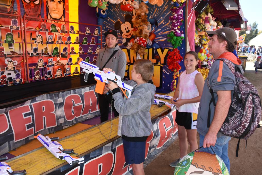 Top Shot: Bede Ryan-White, Skye Ryan-Long and Dean White try to take out the targets and claim their reward. Come down and try your luck at one of the many games at the 150th Royal Bathurst Show. Photo: Nadine Morton.