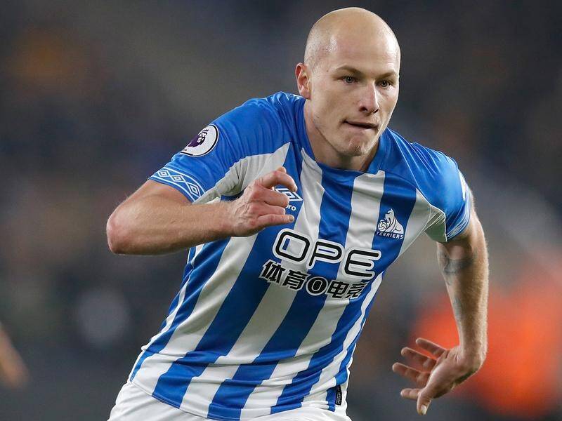 Huddersfield Town's Aaron Mooy was selected in Australia's Asian Cup squad despite a knee injury.
