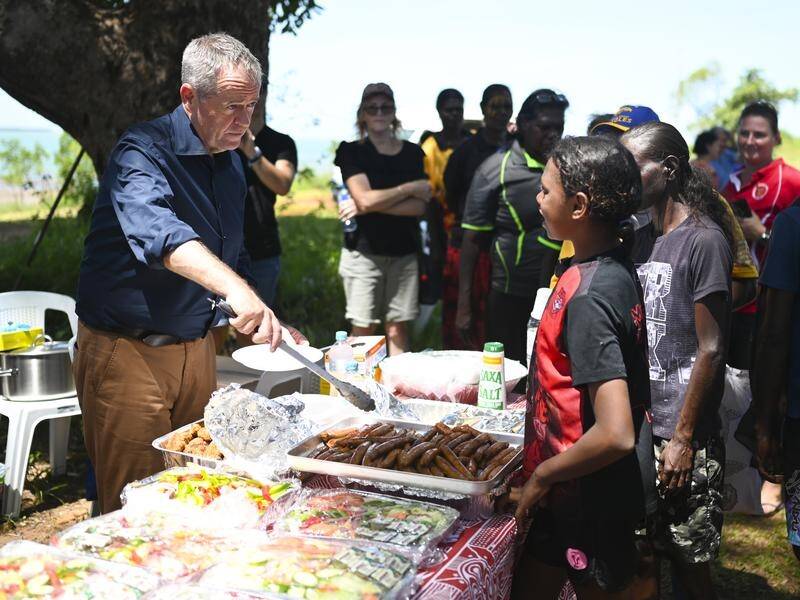 Labor leader Bill Shorten hands out food at a community barbecue on Bathurst Island near Darwin.
